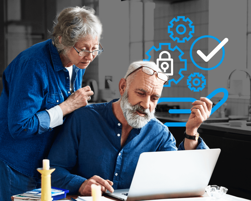 Um casal de idosos, um sentado e outro de pé, numa mesa de jantar, a olhar para um computador portátil. Por detrás deles, surgem ícones de engrenagens e marcas de verificação para indicar a recuperação de identidade.